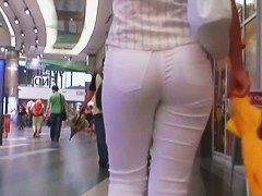 Beauty in tight white pants stars in a candid street video