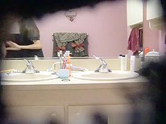 Hot girl getting dressed in front of mirror