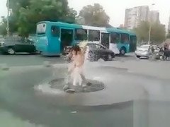 Nude chick washing her pussy on the street