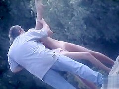 nudist chick poses for photos as friends hold her