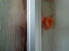 Peep her ride the sticky dildo in a shower