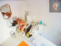 A magnificent brunette takes a piss in a bathroom porno video